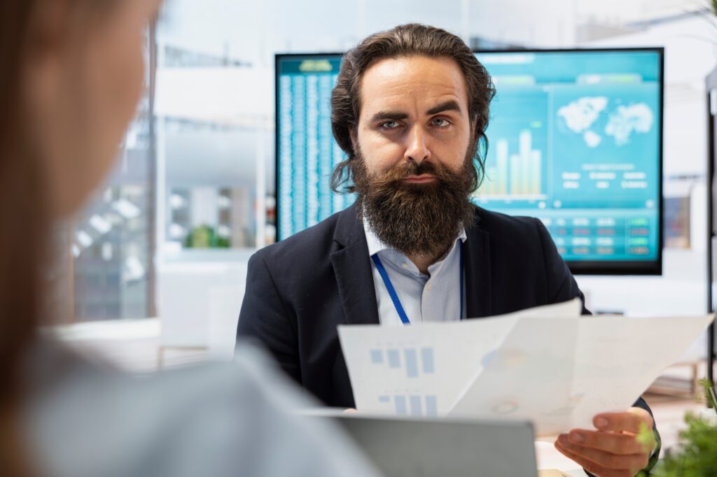 Agent talking with family, offering advice on investing and stock market trading
