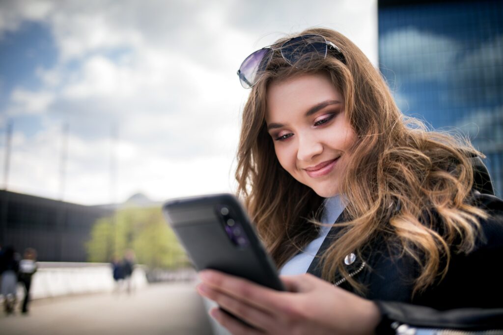 Young woman using smarthphone in modern city